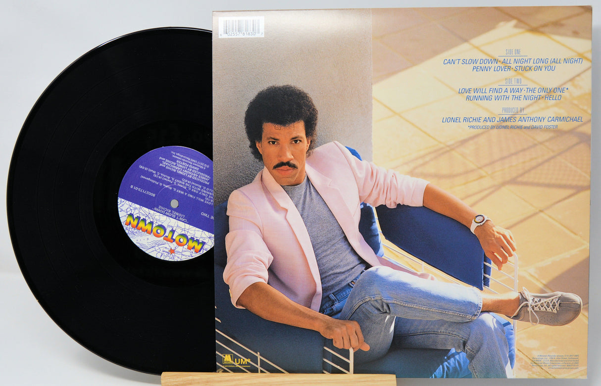 Vinyl record and cover featuring a person sitting on a couch.