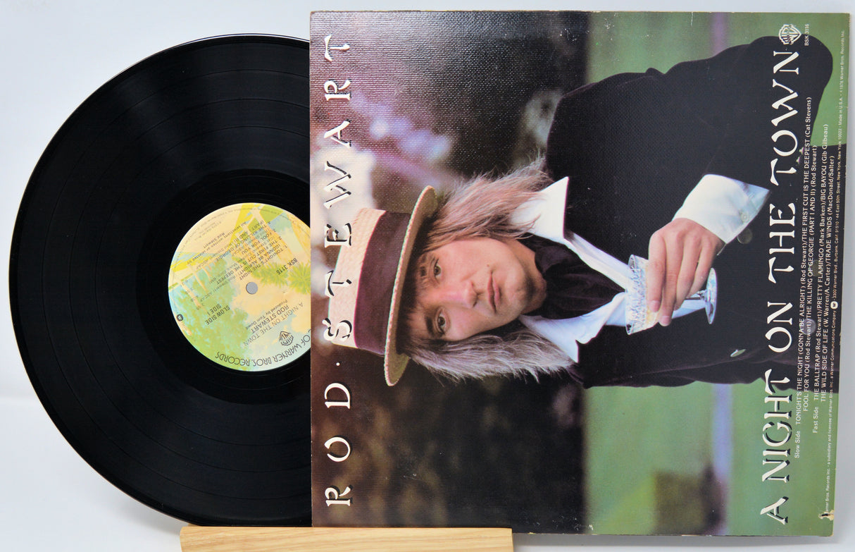 Vinyl record with cover featuring a person wearing a hat, on a light gray background