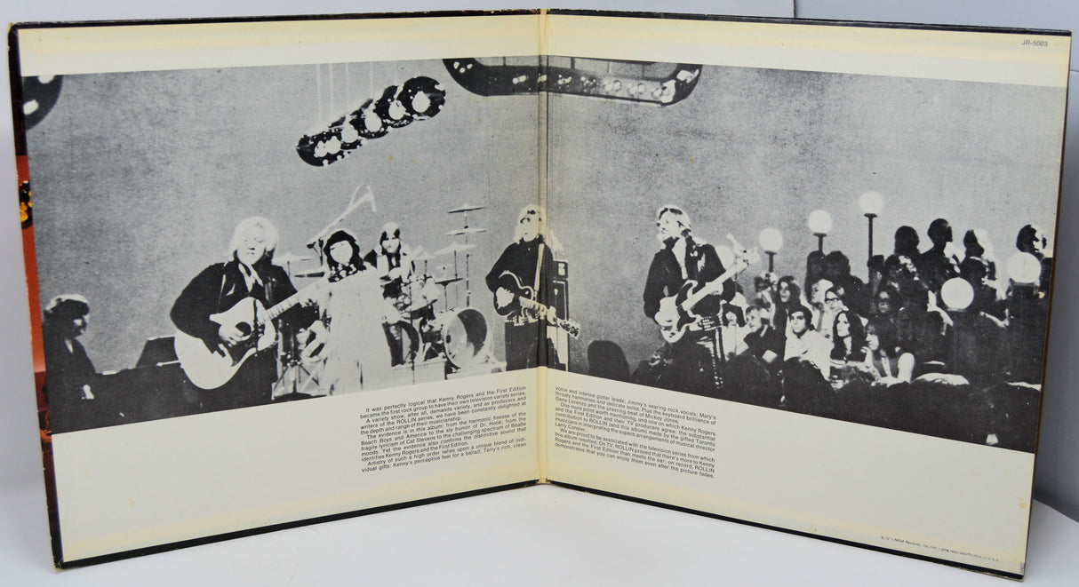 Open book with black and white photograph of a band on stage.