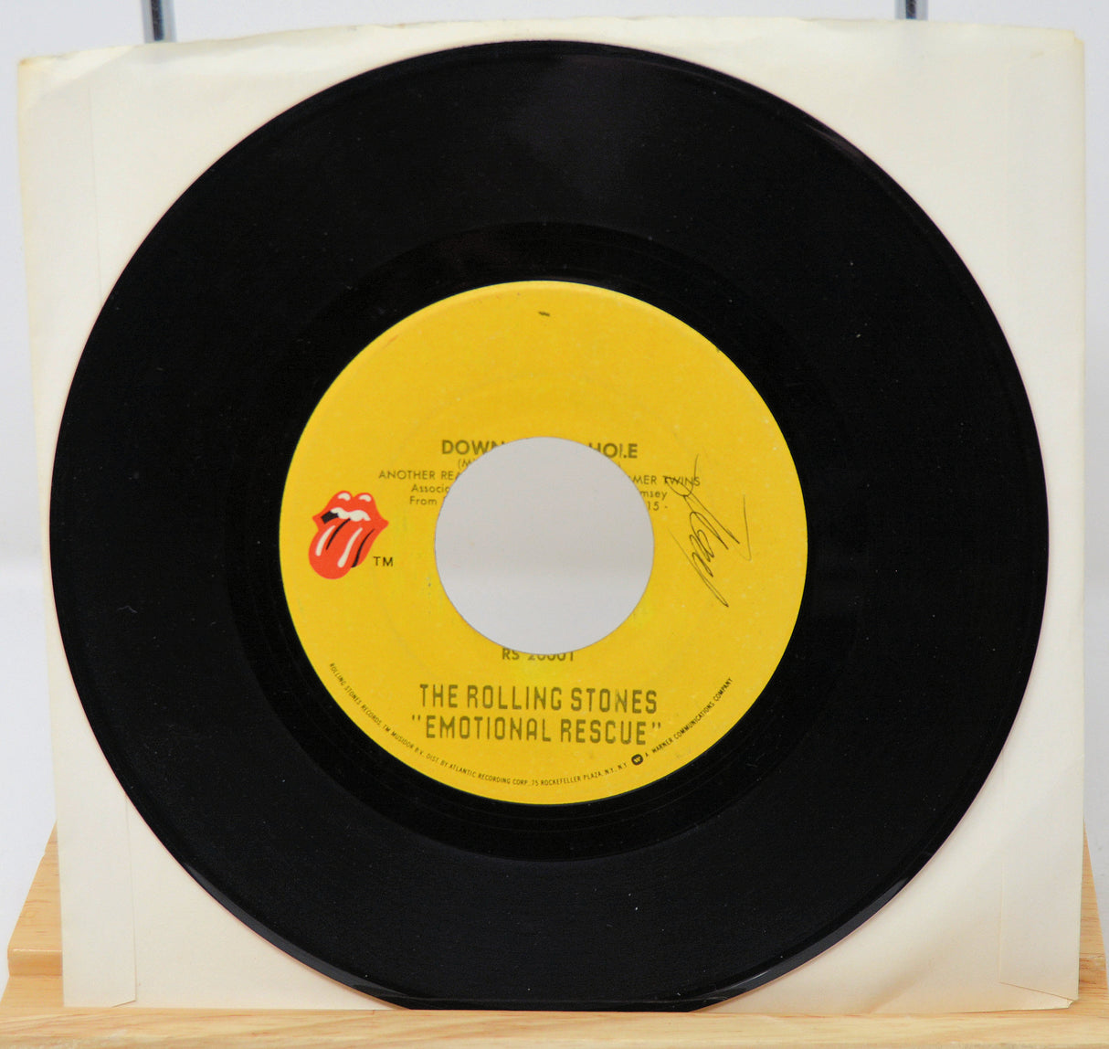 Vinyl record with yellow label featuring The Rolling Stones logo on a white background