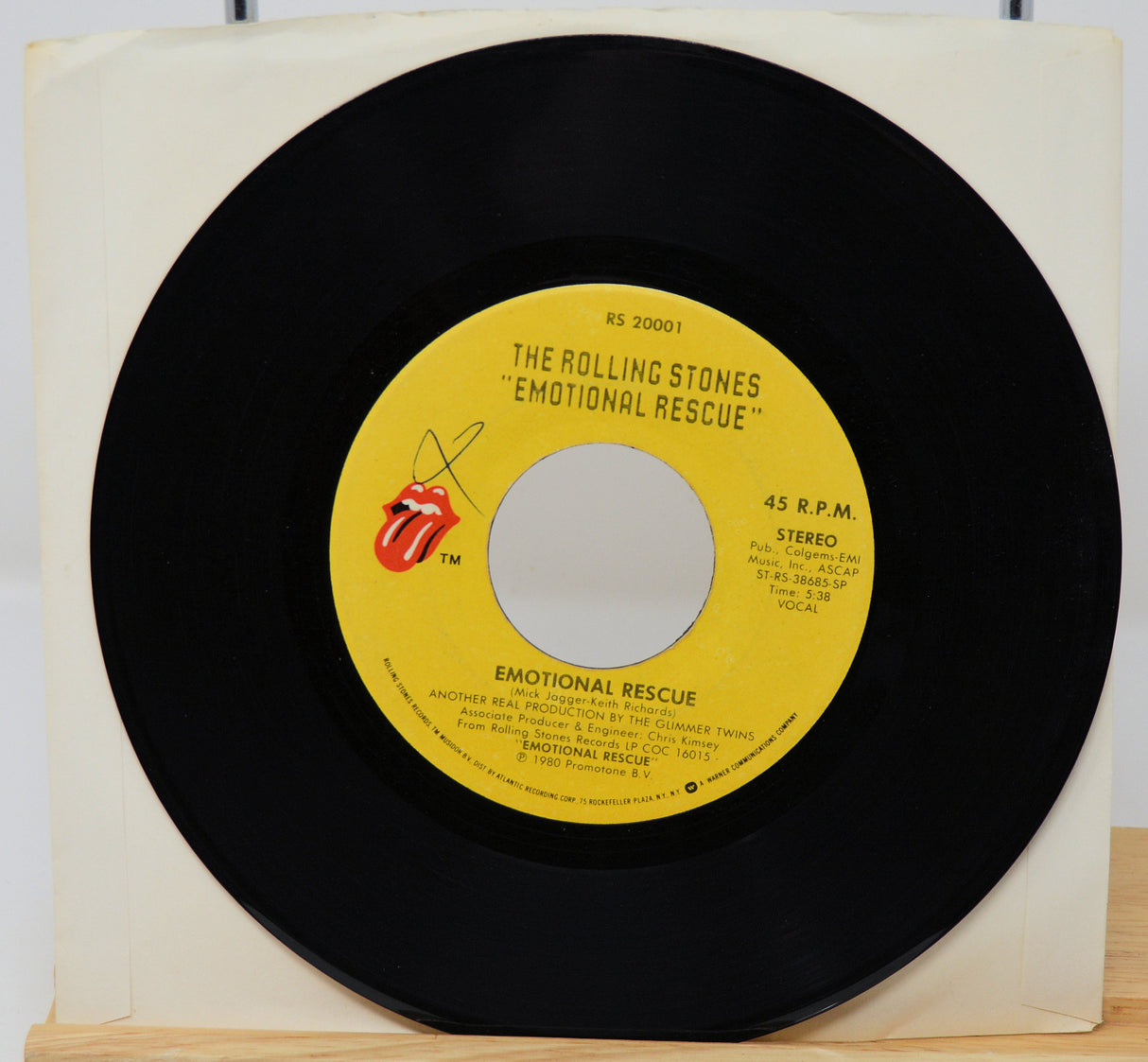 Vinyl record with yellow label featuring The Rolling Stones on a white background