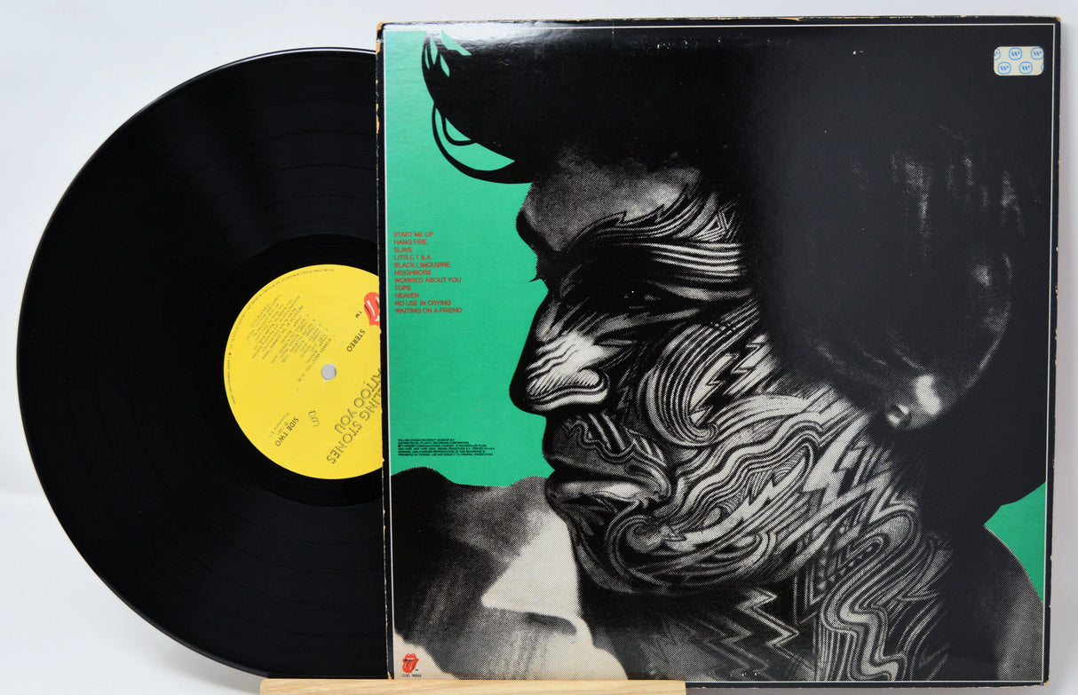 Vinyl record with a stylized cover featuring a tattooed face.