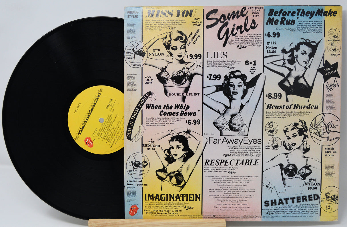 Vinyl record with a colorful album cover featuring vintage-style illustrations and text.