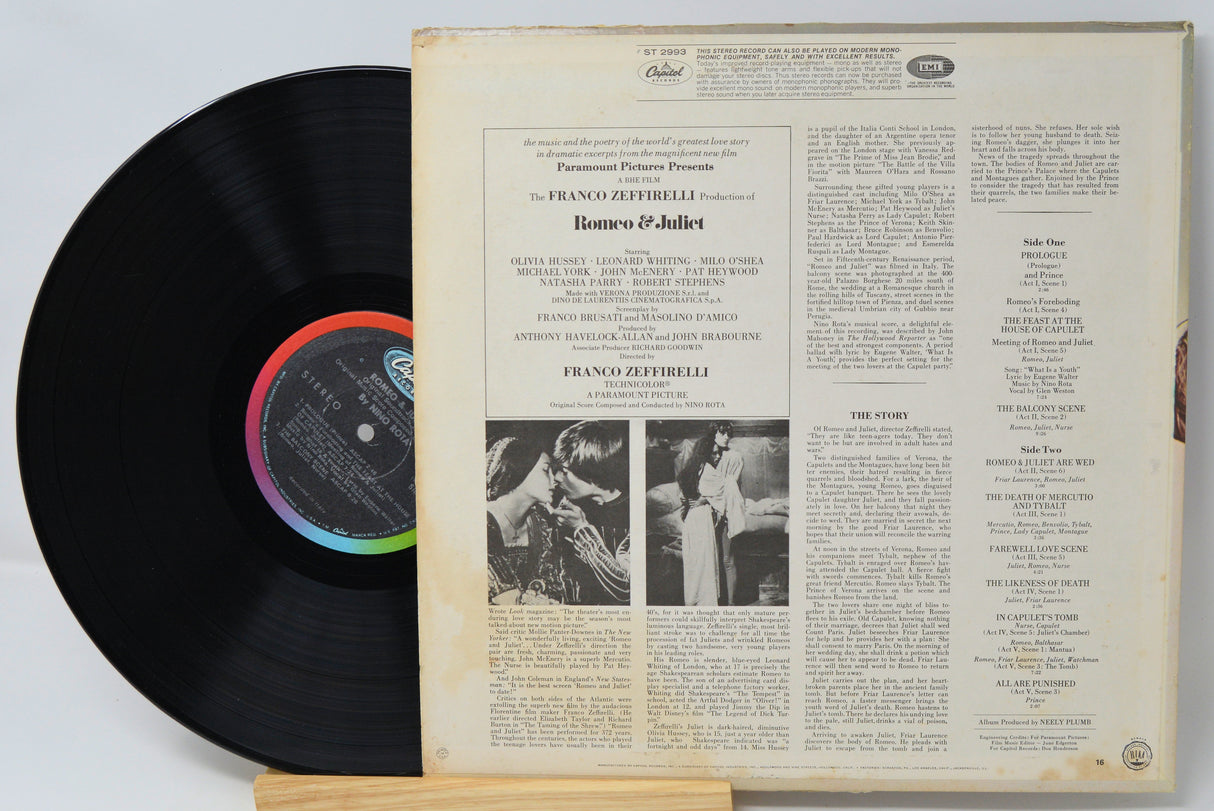 Vinyl record with cover featuring text and images on a light gray background
