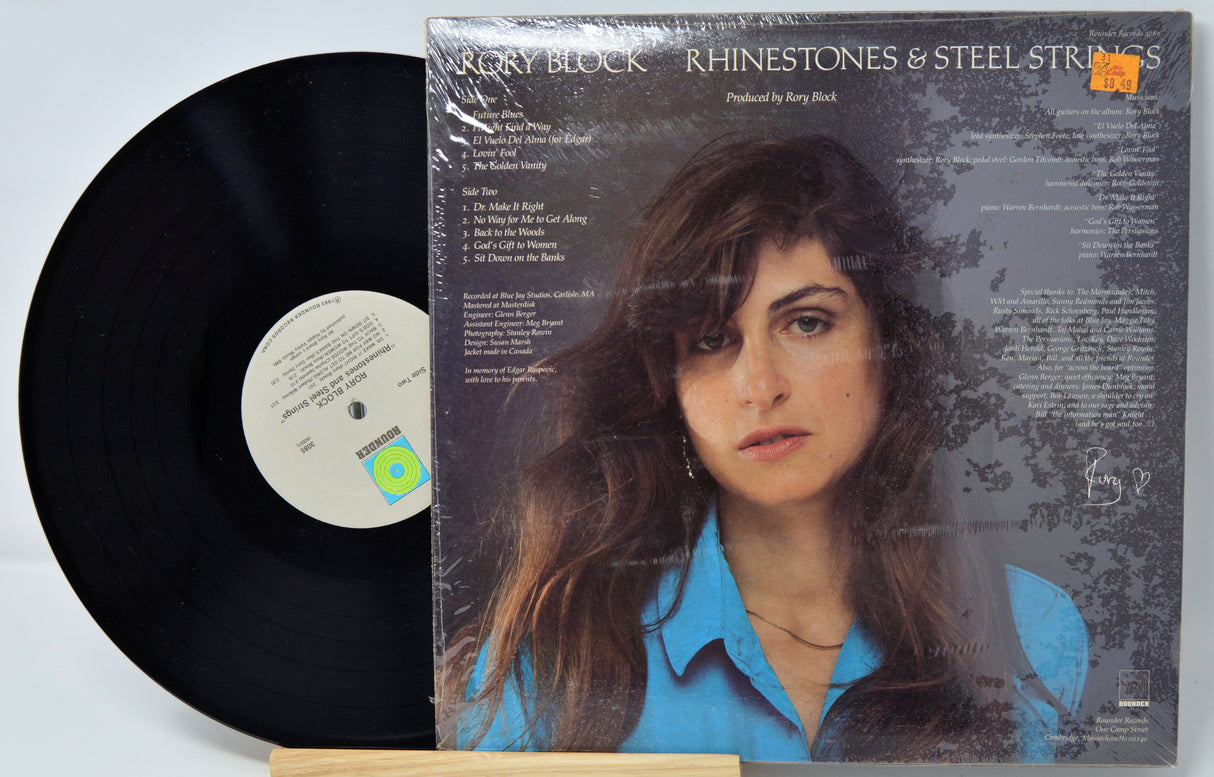 Vinyl record with cover featuring a person's portrait on a light blue background