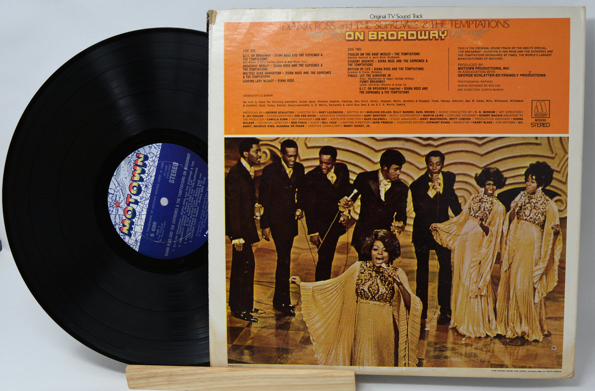 Vinyl record with cover featuring The Temptations on a light gray background
