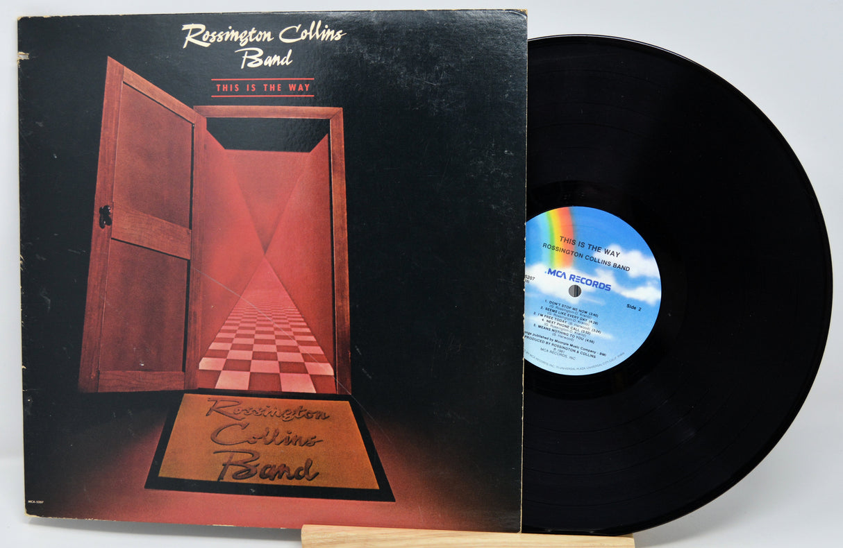 Vinyl record with a mountain-themed cover featuring a person holding a suitcase.