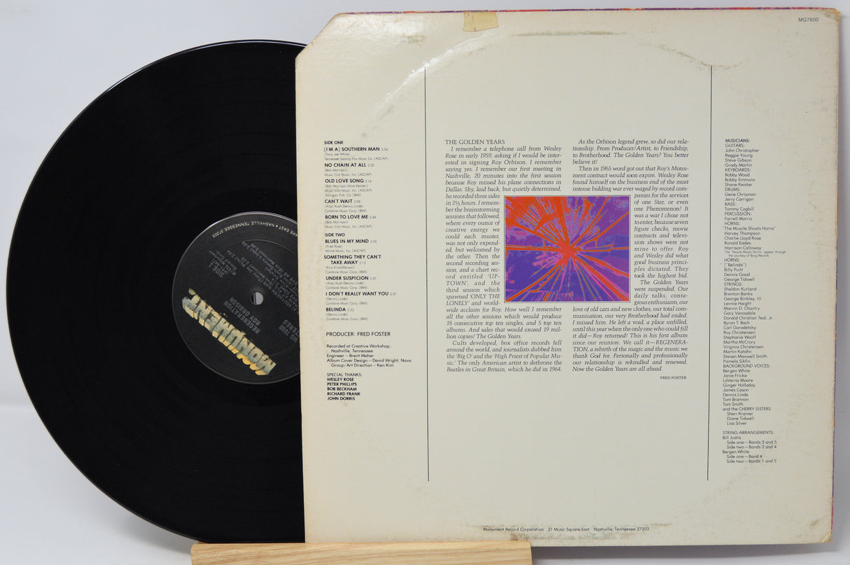 Vinyl record with cover featuring text and a colorful abstract design on a white background