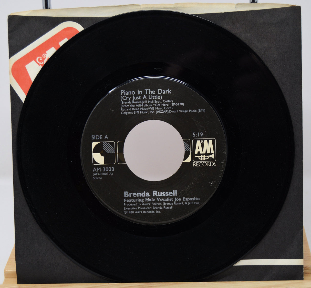 Vinyl record with AM Records label on a white background