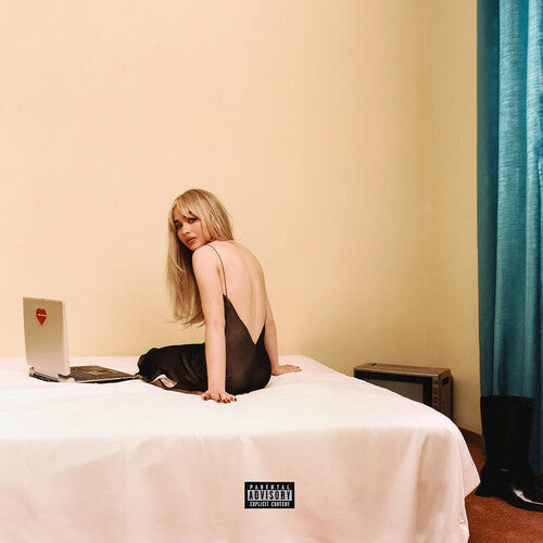 Album cover with a person sitting on a bed next to a laptop, with a visible record label logo.