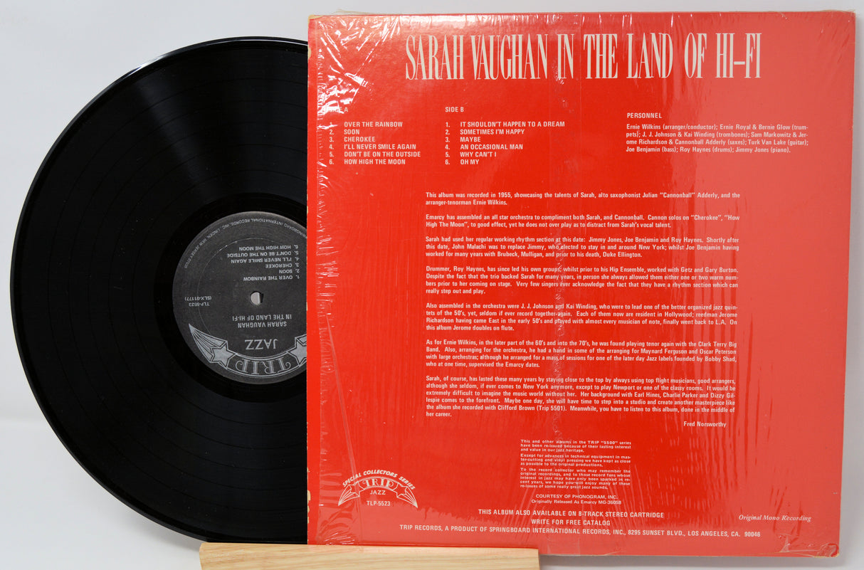 Vinyl record with red cover featuring text and a logo on a white background