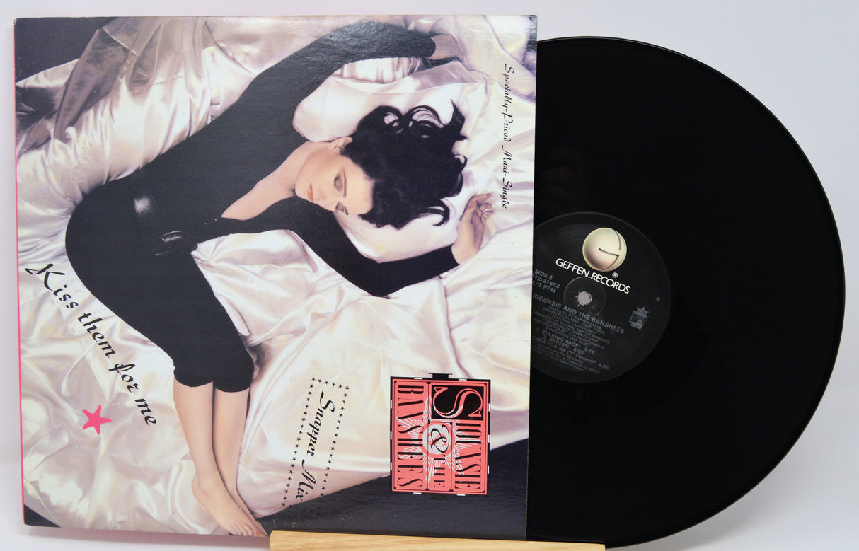 Vinyl record with cover featuring a person lying down, on a white background