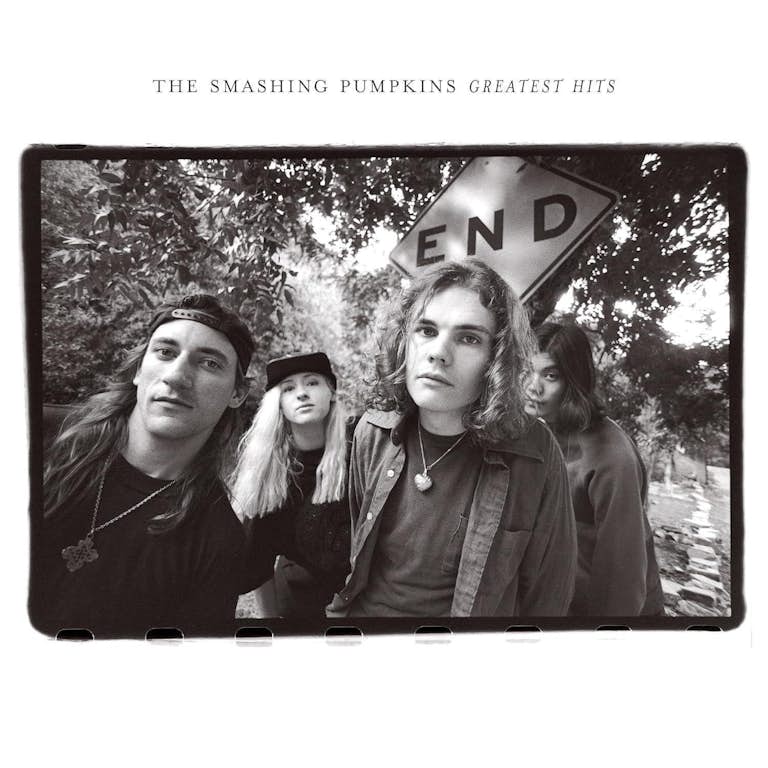 The image shows the cover art for 'Rotten Apples: Greatest Hits' by The Smashing Pumpkins. The band members are pictured from behind, wearing casual clothing, with a sign in the background that reads 'END'.