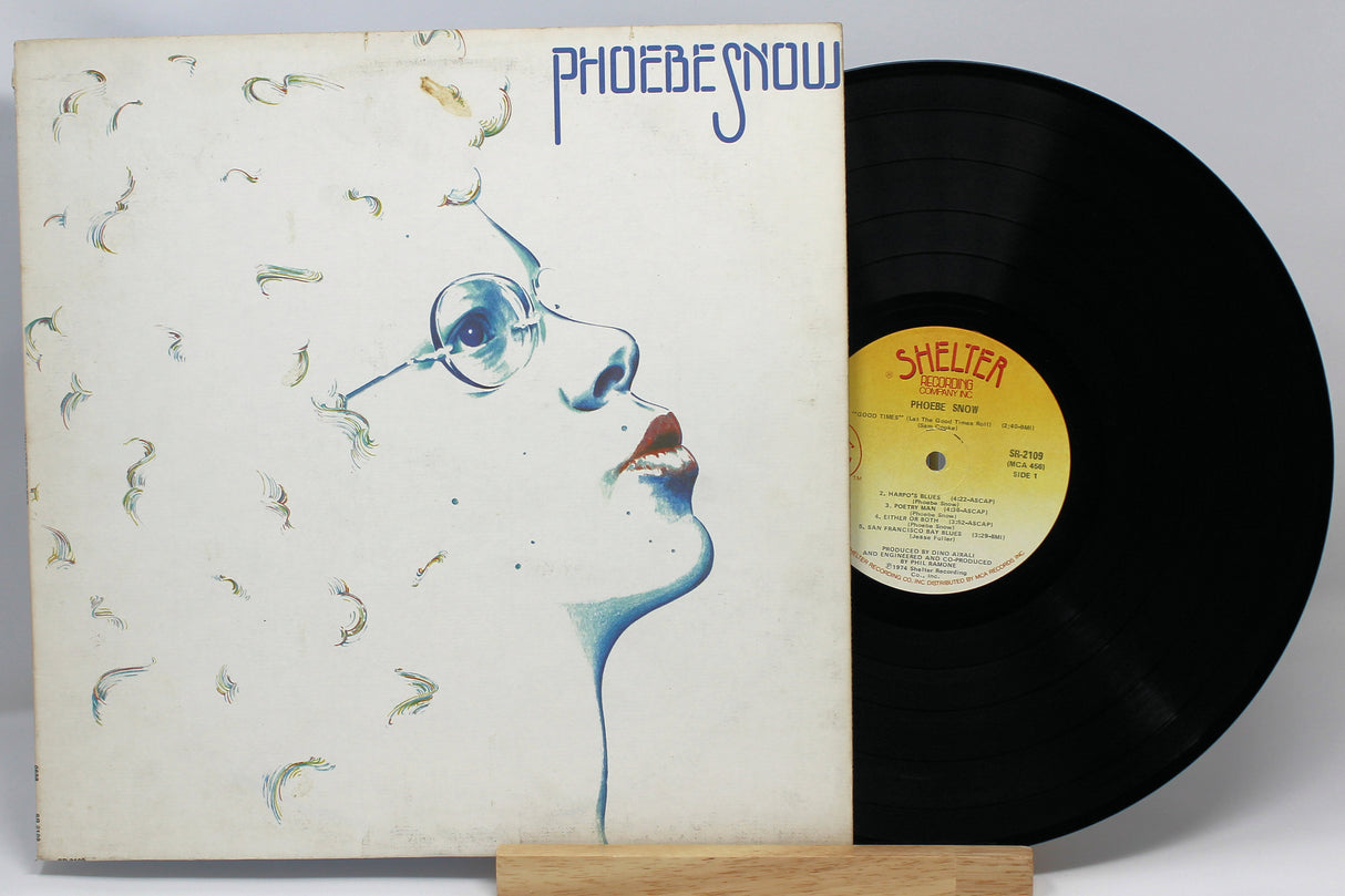A vinyl record titled 'Phoebe Snow - Self Titled' with the corresponding album cover art featuring a stylized image of a woman's face, believed to represent the artist Phoebe Snow.