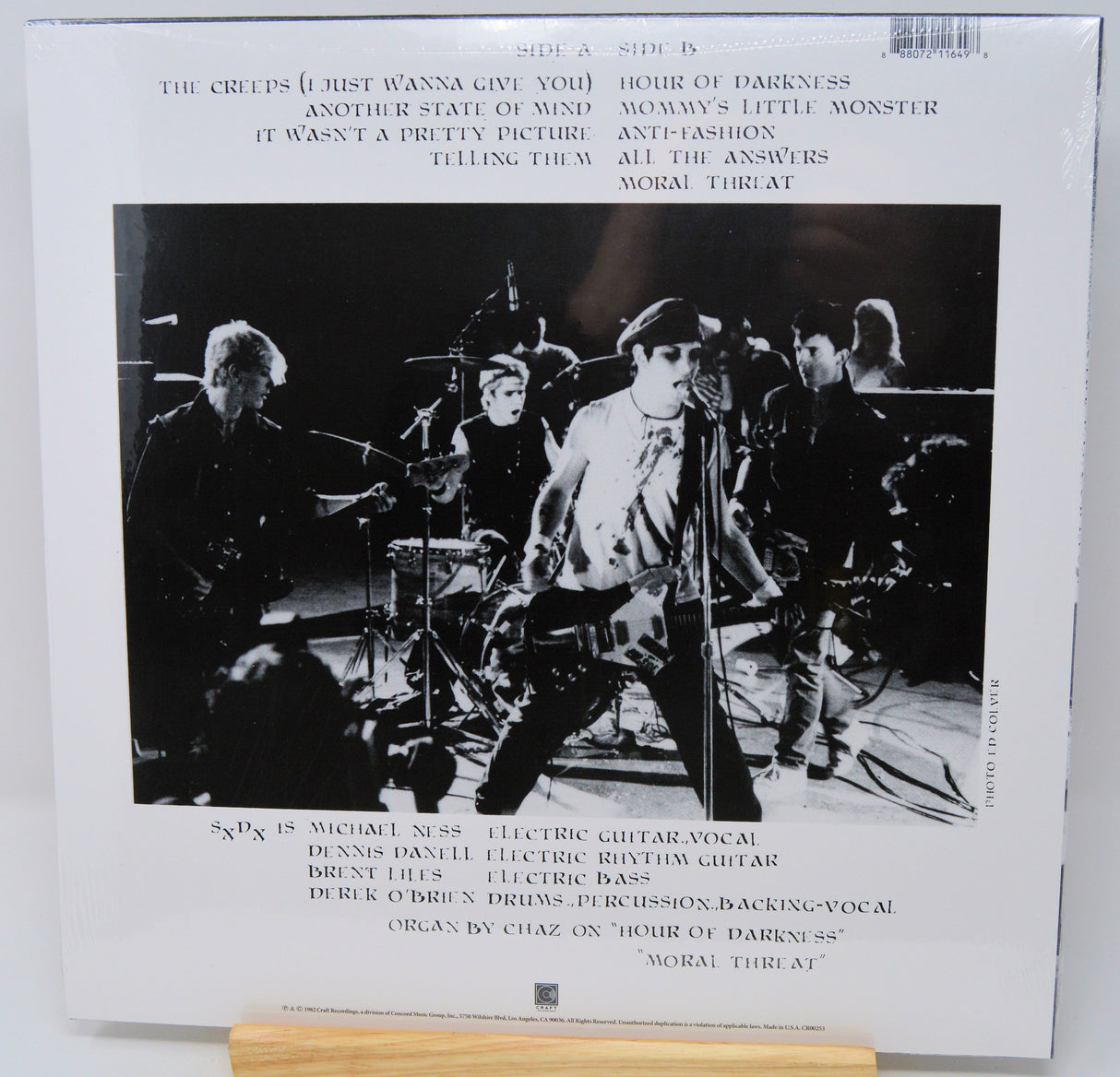 Vinyl record with a black and white photo of a band on the cover, featuring text and a barcode.