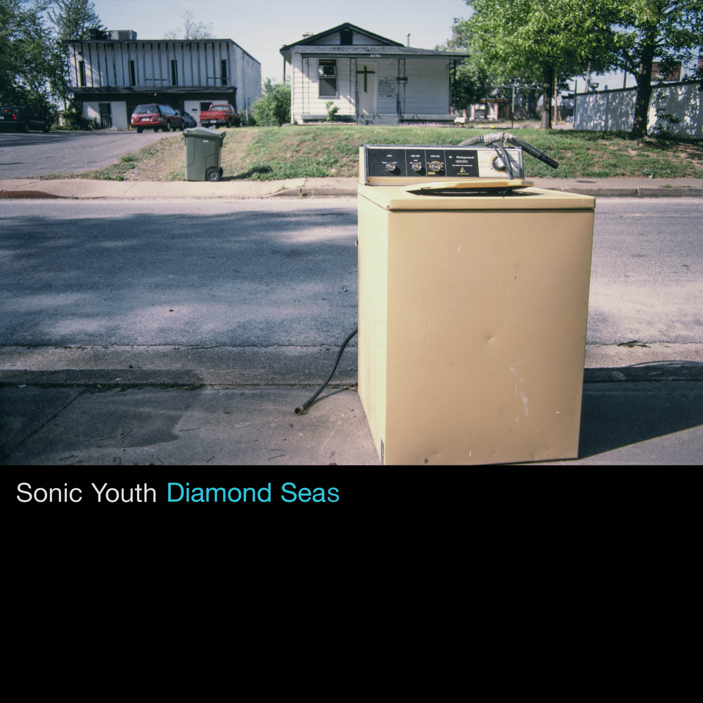 Album cover of 'Diamond Seas' by Sonic Youth with a washing machine on a street.