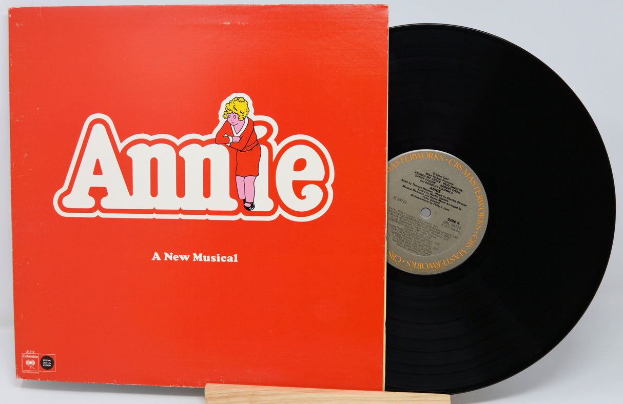 Vinyl record and cover for 'Annie: A New Musical' on a white background