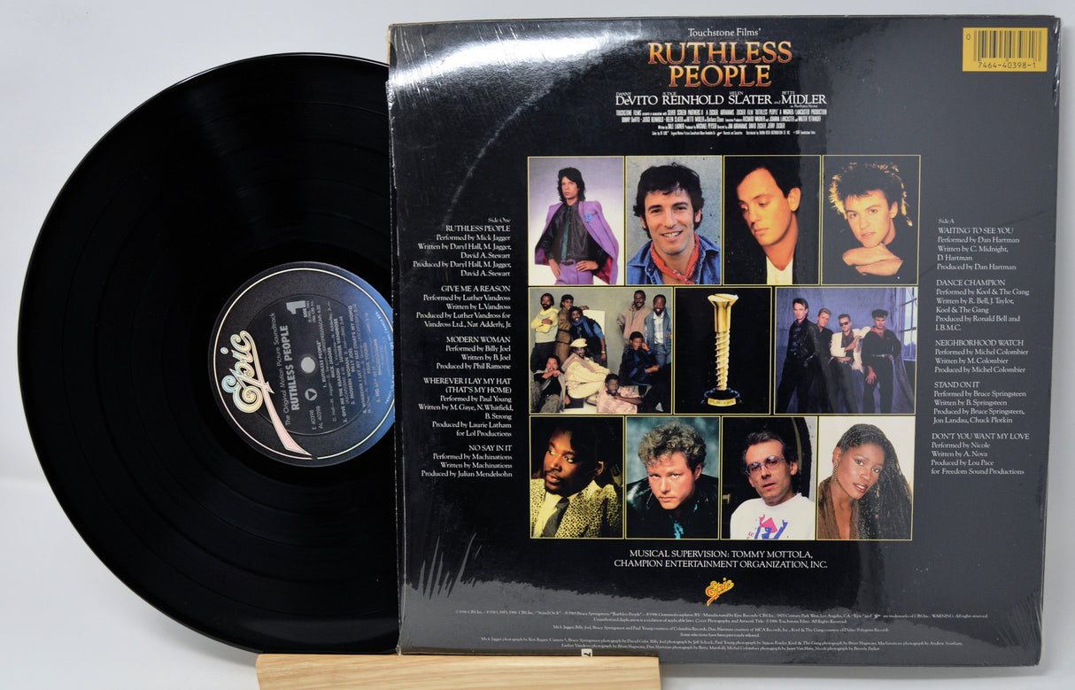 Vinyl record with its cover featuring a collage of images and text on a gray background