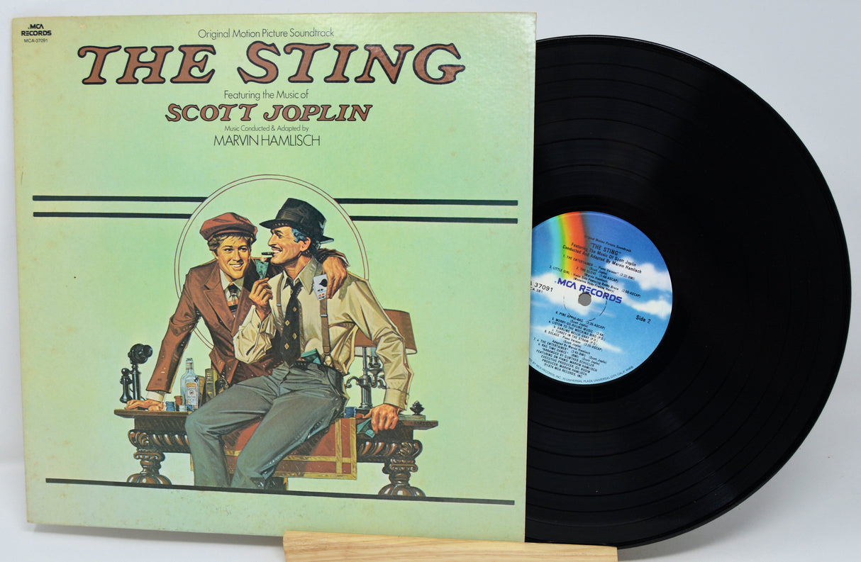 Vinyl record with cover featuring 'The Sting' and Scott Joplin, on a light gray background