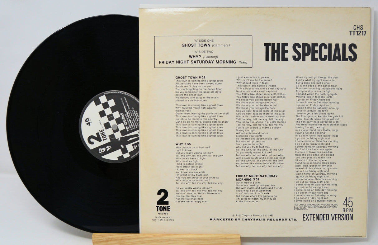 Vinyl record and its cover with 'The Specials' album details on a light gray background