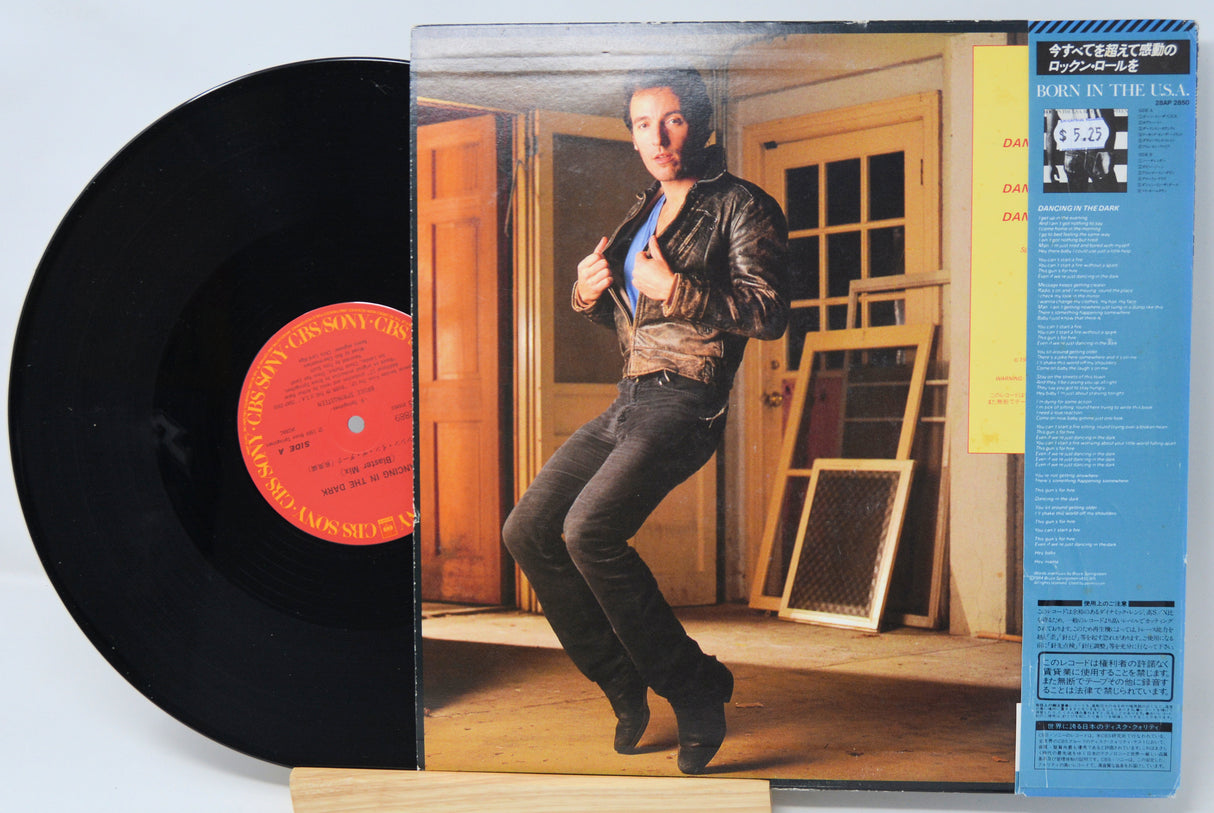 Vinyl record with cover featuring a person in a room.