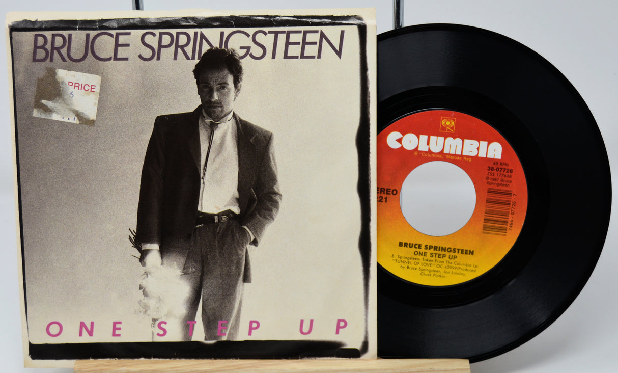 Vinyl record and cover of Bruce Springsteen's 'One Step Up' with Columbia label.