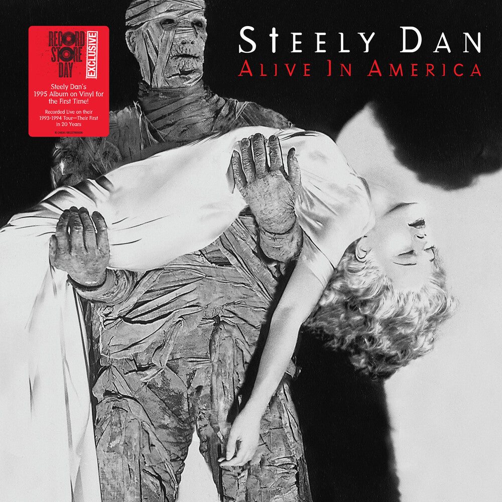 Album cover for 'Alive In America' by Steely Dan featuring a black and white image of a mummy and a woman.