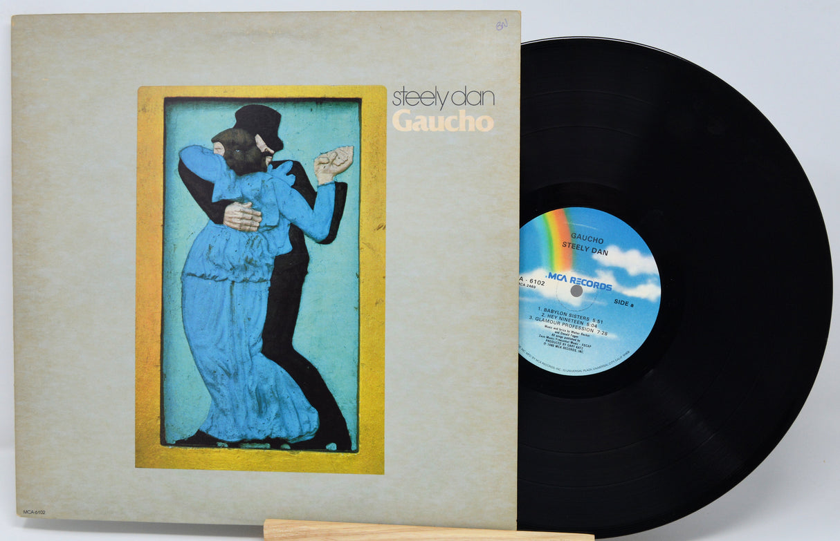 Vinyl record with cover featuring a couple dancing, labeled 'Steely Dan Gaucho'.