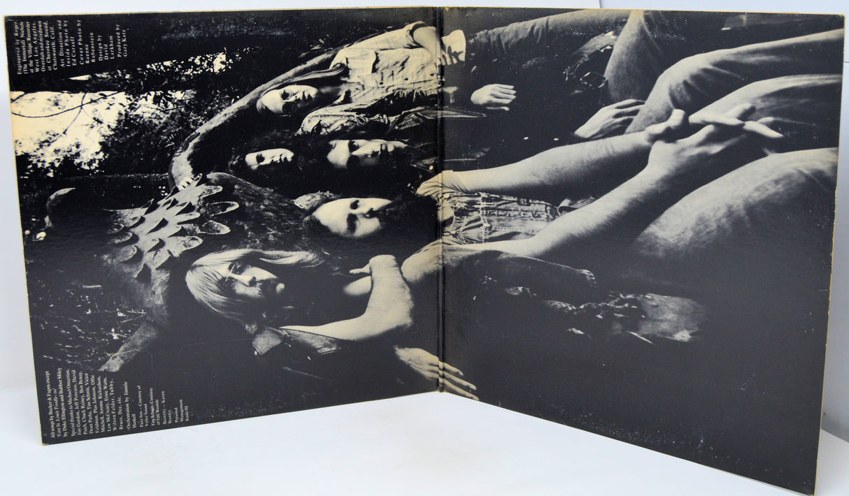 Black and white album cover with a group of people lying down.