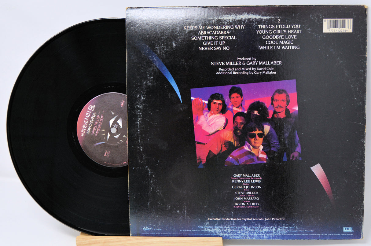 Vinyl record with cover featuring a band photo and text on a white background