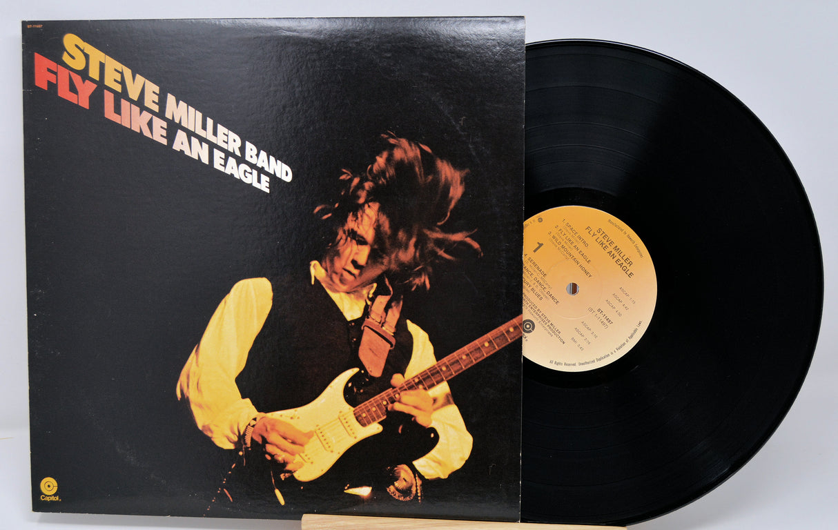 Vinyl record with cover featuring a musician playing guitar, titled 'Fly Like an Eagle' by Steve Miller Band.