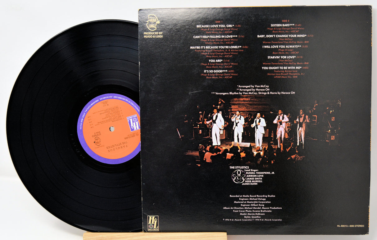 Vinyl record with cover featuring a band on stage