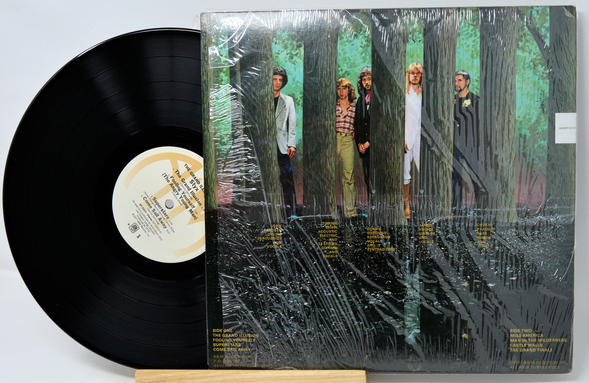 Vinyl record with a cover featuring people in a forest setting