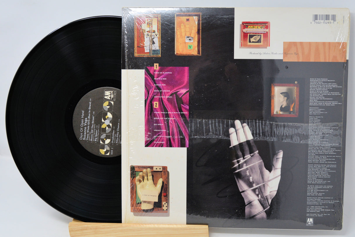 Vinyl record with a colorful cover featuring a hand and text on a white background