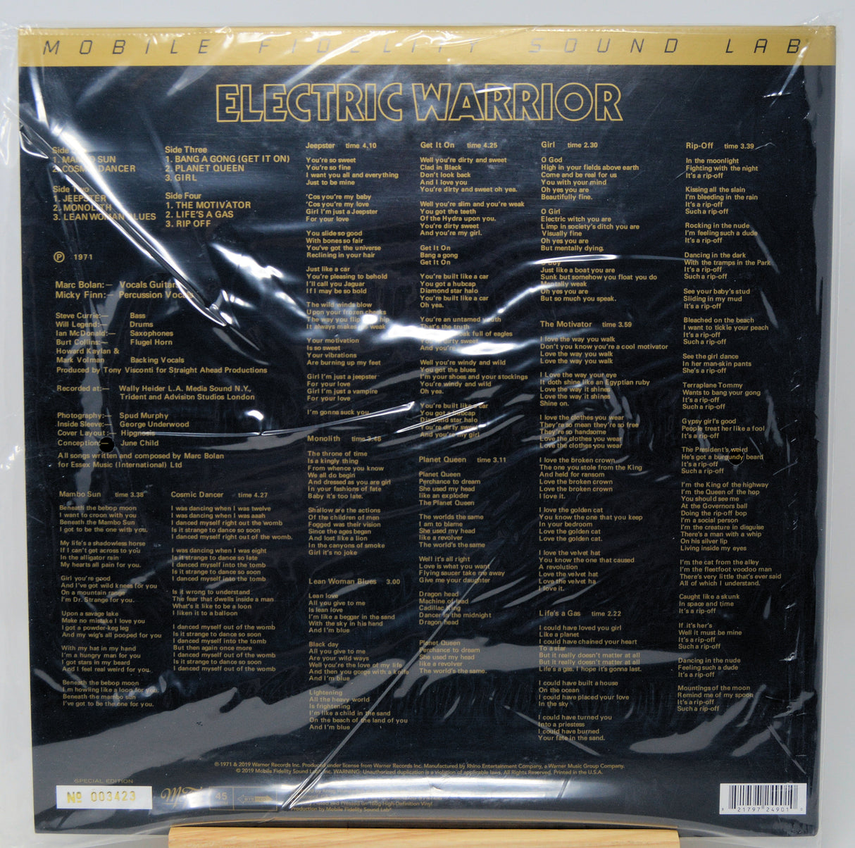 The back cover of the Electric Warrior vinyl record LP by Mobile Sound Lab, sealed in its original plastic shrink wrap. The cover is black with gold text and features a tracklist.