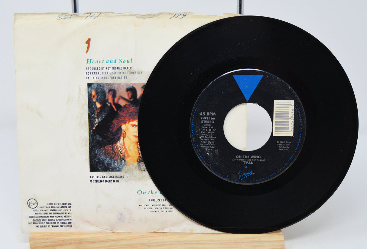 A vinyl record of T'Pau - Heart And Soul with a visible label showing tracklisting and the band's logo.