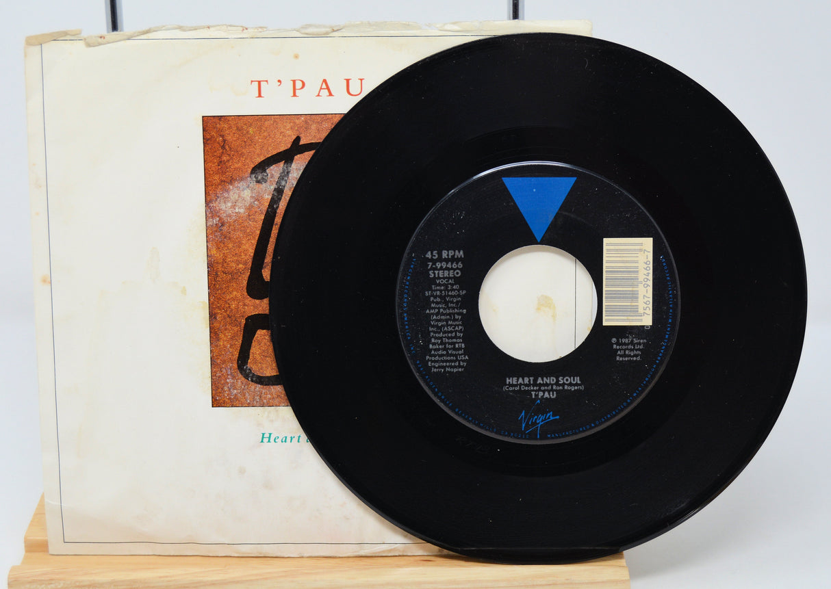 A vinyl record of T'Pau - Heart And Soul with a visible label showing tracklisting and the band's logo.