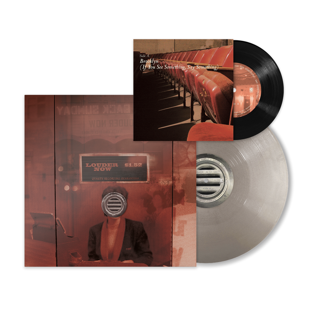 Vinyl record album shown with the sleeve, a printed insert, and a translucent silver record on a white background. The artwork is dominated by warm red and brown tones, with black from the vinyl disc.