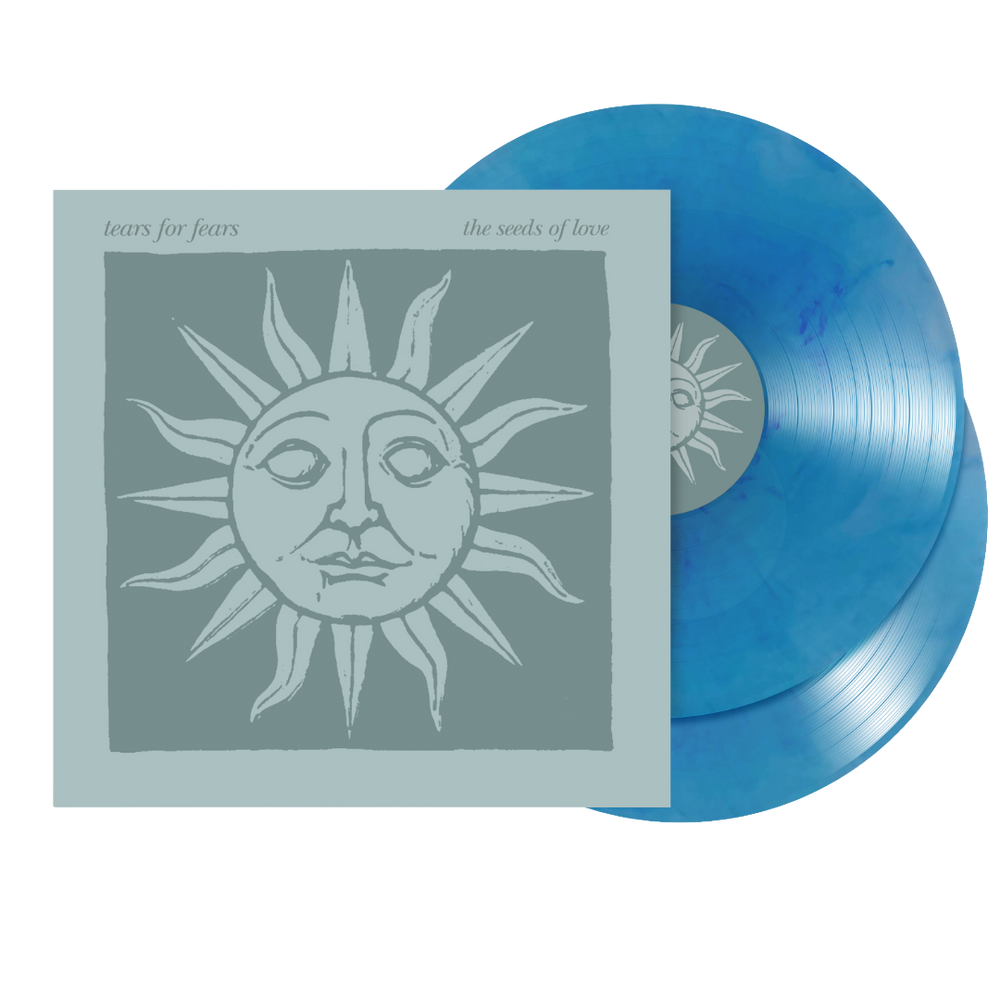 Tears for Fears - 'The Seeds of Love' double vinyl LP with a dusty blue sleeve featuring a stylized sun illustration, and two translucent blue vinyl records partially visible behind it.