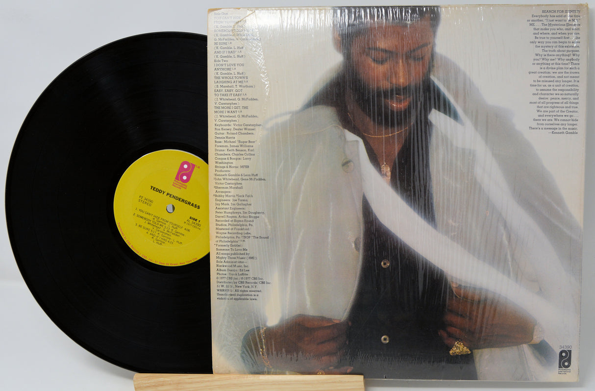 Vinyl record with a yellow label and cover featuring a person holding a stringed instrument.