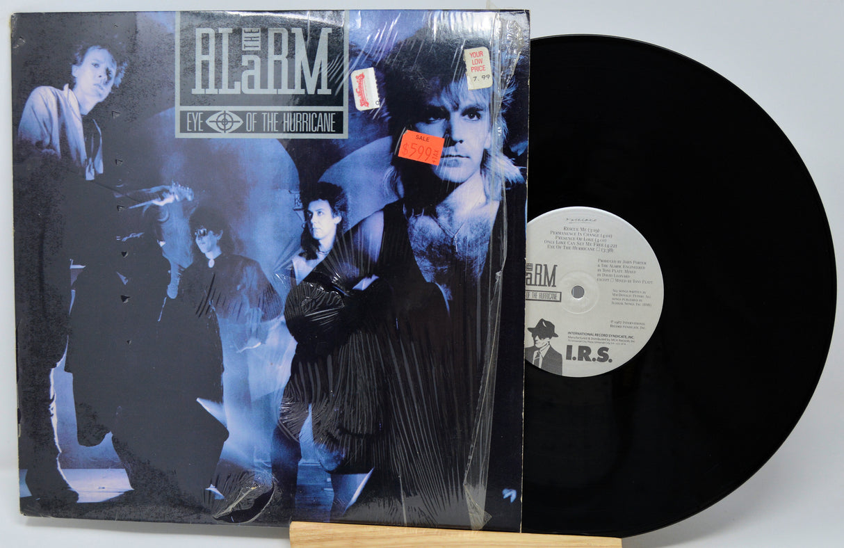 Vinyl record with cover featuring a band and text 'The Alarm' on a white background