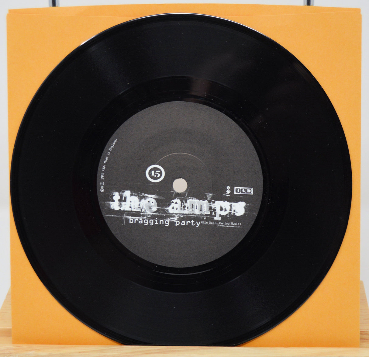 The Amps Bragging Party 7-inch vinyl record with orange sleeve