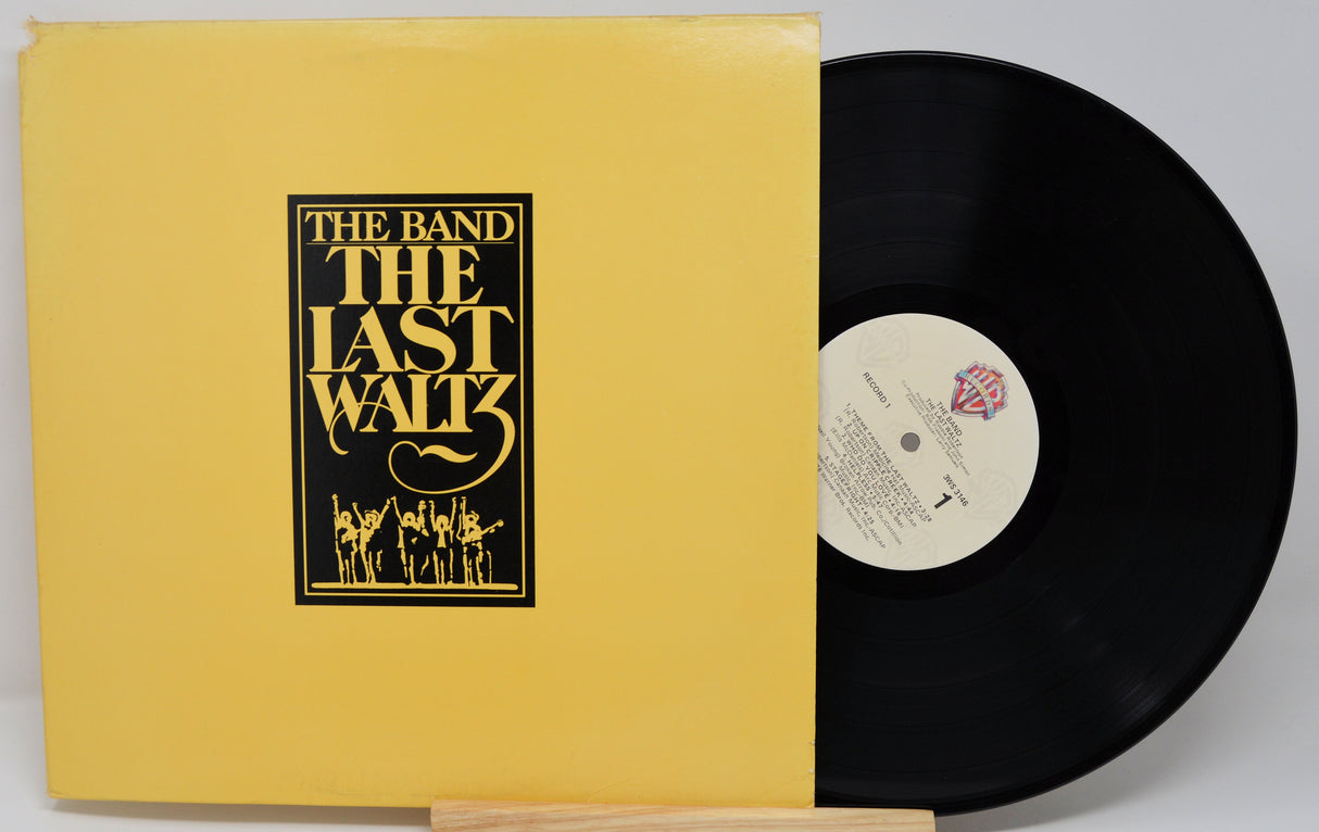 Vinyl record and cover of 'The Last Waltz' by The Band on a gray background