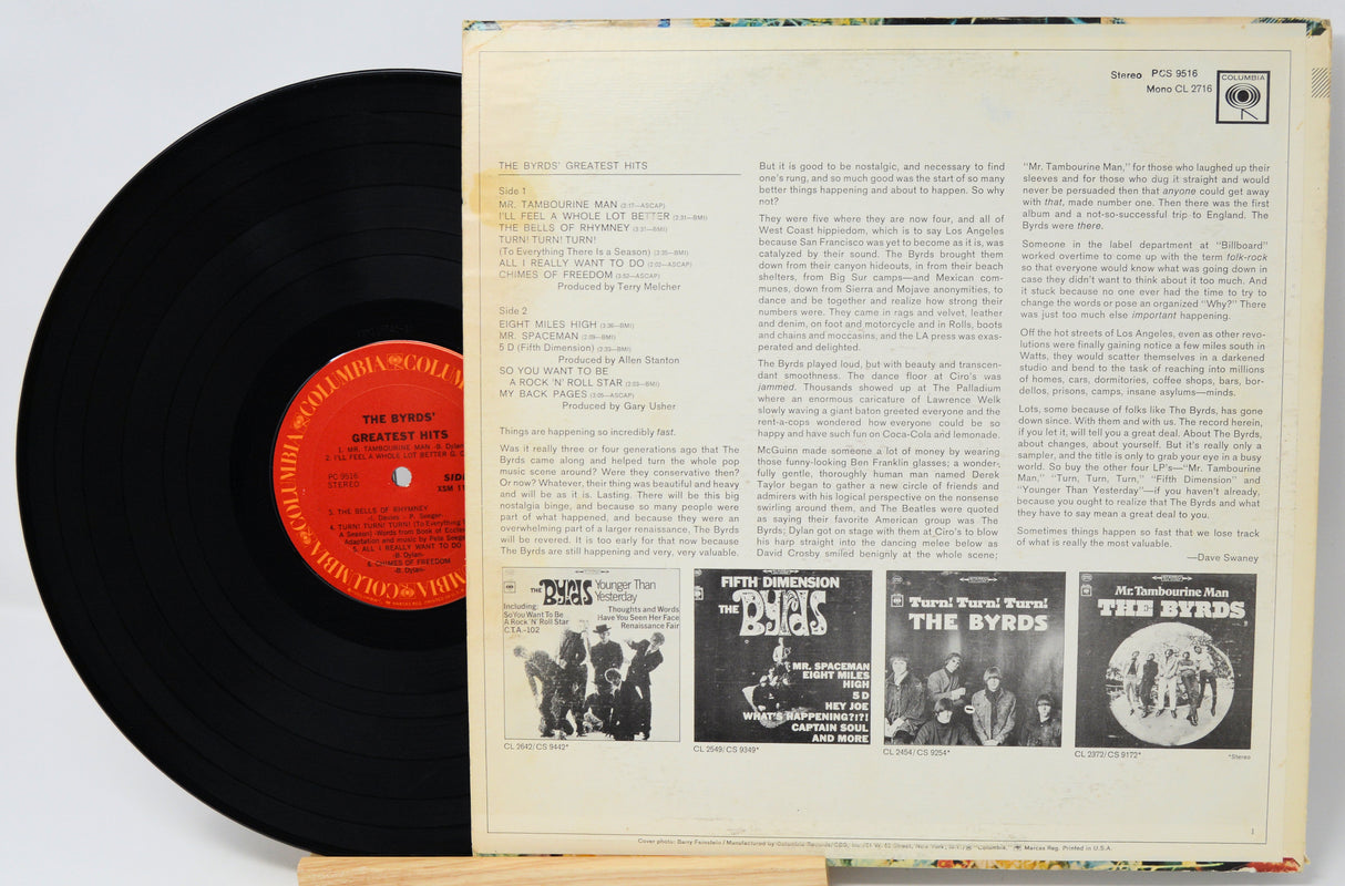 Vinyl record with cover featuring text and black and white images of band members.