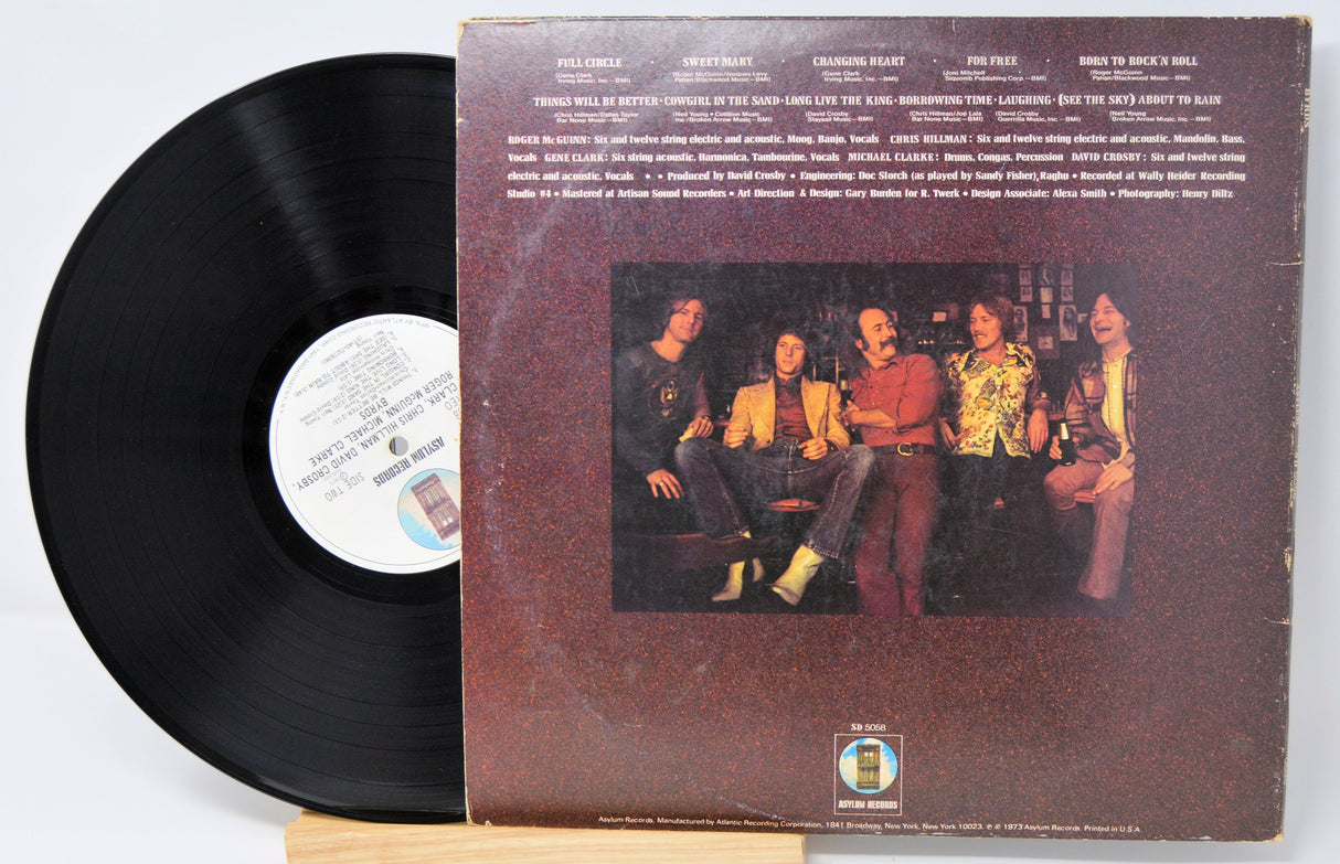 Vinyl record with cover art featuring a group of people.