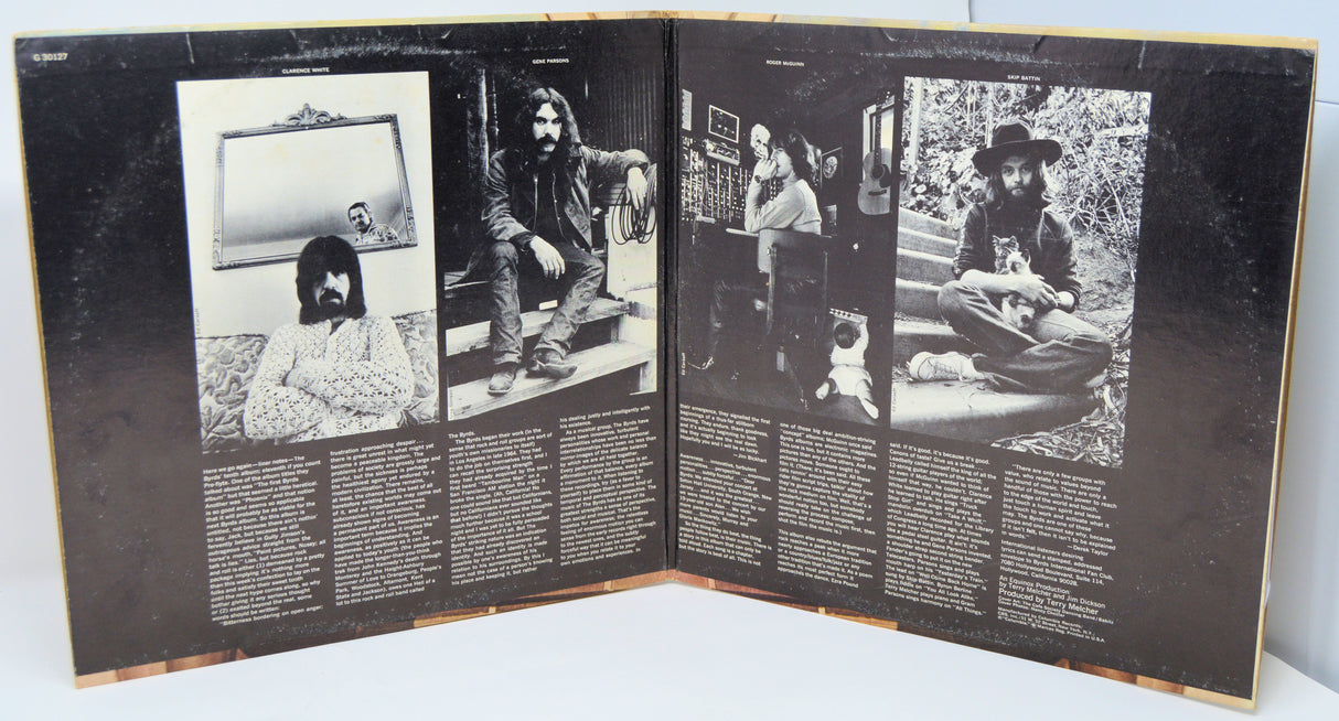 Open record gatefold with black and white photos and text.