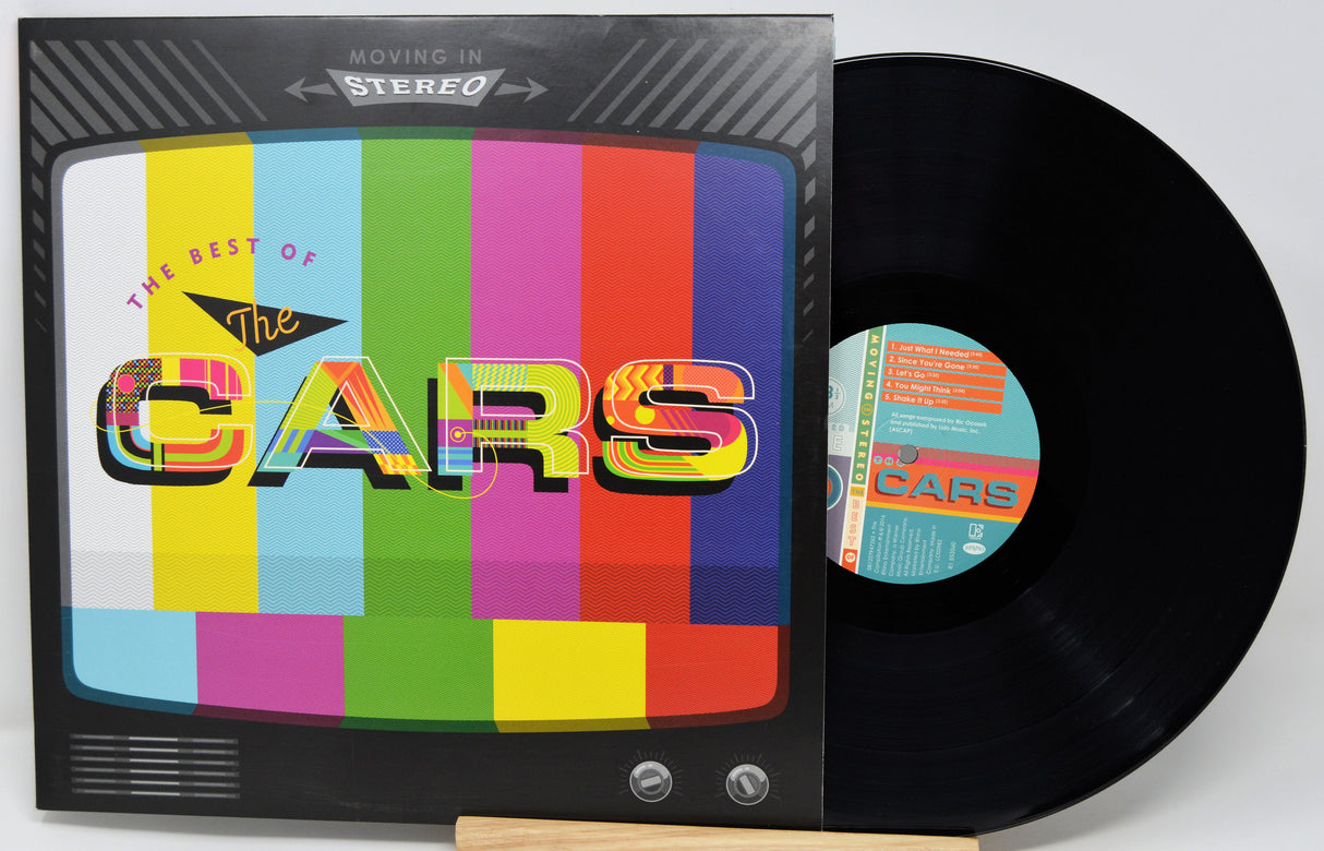 Vinyl record with colorful cover featuring 'The Cars' on a white background