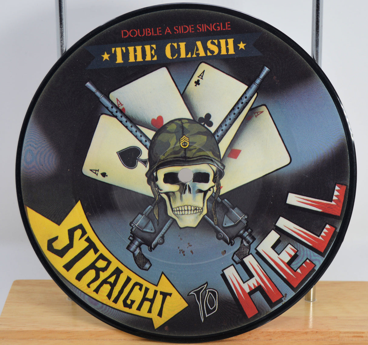 The Clash 'Should I Stay or Should I Go' Vinyl Picture Disc with skull and cards design, featuring 'Straight To Hell' text.