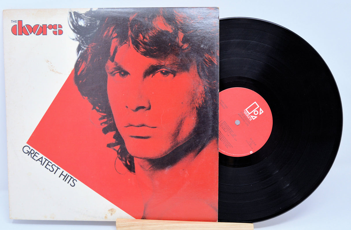 Vinyl record and cover with a stylized portrait on a light blue background