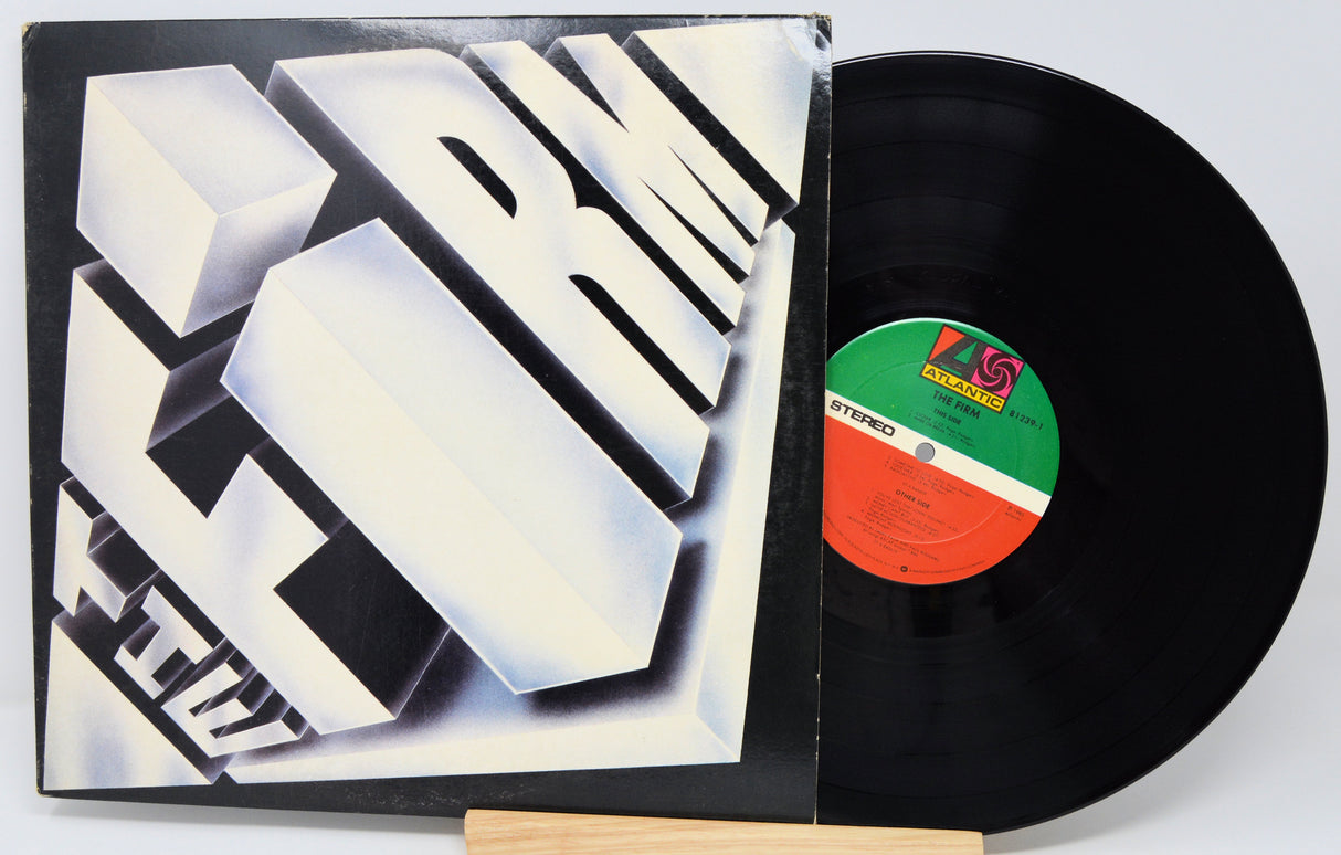 Vinyl record with a black cover featuring geometric design and a visible label.